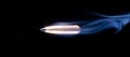 Flying bullet on black with smoke trailing behind