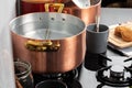 Copper pot with boiling water on a gas stove Royalty Free Stock Photo