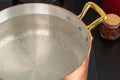 Copper pot with boiling water on a gas stove Royalty Free Stock Photo