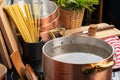 Copper pot with boiling water on a gas stove Royalty Free Stock Photo