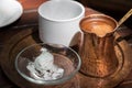 Greek coffee copper pot on a tray.