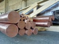Copper rods of round billets various diameters in warehouse Royalty Free Stock Photo