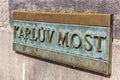 Copper sign with the name of the Charles bridge Karluv Most in Prague