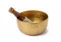 Copper singing bowl and wooden clapper on a white background. Musical instrument for meditation, relaxation, various medical