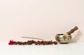 Copper singing bowl and wooden clapper on a white table. Musical instrument for meditation, relaxation, various medical practices