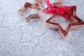 Copper star-shaped cookies cutter for Christmas on shiny mirrored background