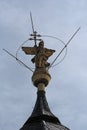 Copper statue of the archangel gabriel on the top of the church of st. marcellinus and st. peter, seligenstadt, hesse, germany Royalty Free Stock Photo