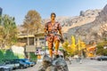 Copper statue of mountain climber in front the entrance of Darband valley of the Tochal mountain. A popular recreational region