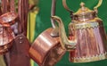 Copper teapot and other kitchenware hanging on the storage site in the restaurant