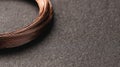 Copper Thermocouple Wire Coiled on a Dark Metallic Plate for Temperature Measurement Applications in Manufacturing Royalty Free Stock Photo