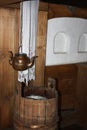 Copper vessel for drinking water (kettle with two spouts) in the interior of a traditional wooden house in the Russian North Royalty Free Stock Photo