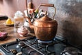 copper vintage kettle on gas stove in modern kitchen