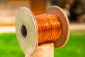 Copper vintage wire on a spool, on top of another metal coil - close up