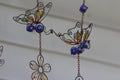 Copper wire, blue marble and colorful beads shaped into butterflies and a flower