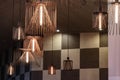 Copper wire chandeliers with chess check wall backdrop