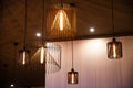 Copper wire chandeliers with chess check wall backdrop