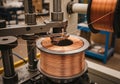 Copper wire spooling in an industrial setting. The machine features a rotating spindle with tightly Royalty Free Stock Photo