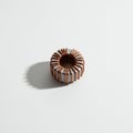 Copper wire wrapped around a toroidal core, likely ferrite, creating an inductor or Royalty Free Stock Photo