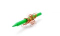 copper wire wrapped on a green crayon on a white background Royalty Free Stock Photo