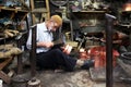 A coppersmith busily making a copper container in the Urfa (Sanliurfa)bazaar in eastern Turkey.