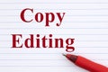 Copy editing with ruled loose leaf notebook paper with a red pen Royalty Free Stock Photo