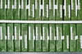 Copy paper reams with generic brand green packaging stacked up in rows.