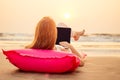 Copy space Beautiful young woman working with laptop on the tropical beach. Happy traveling female using laptop on Royalty Free Stock Photo