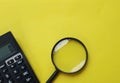 Copy space  black magnifying glass and calculator on yellow background.Business and finanse concept Royalty Free Stock Photo