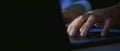 Copy space of businessman hands using computer laptop with the press keyboard at office and nighttime. Royalty Free Stock Photo