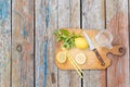 Copy space. Chopping cutting board, sliced lemon, jar, mint leaves, knife and straw on wooden table. Cocktail Royalty Free Stock Photo