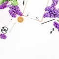 Copy space with clipboard, scissors, pen, lilac branches and accessories on white background. Flat lay, top view. Beauty blog conc Royalty Free Stock Photo