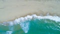 COPY SPACE: Flying above turquoise ocean waves washing the empty sandy beach. Royalty Free Stock Photo