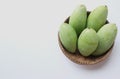 Fresh organic Barracuda mangoes fruit in a beautiful Thai wicker on white background in Thailand. Tropical fruit in thailand.