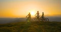 COPY SPACE: Friends observe the sunset after a cross country biking adventure.