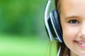 Copy space and half face of young attractive caucasian girl listening music with professional DJ headphones Royalty Free Stock Photo