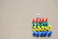 Colorful push pins arranged in an orderly row On a brown backdrop Copy space Royalty Free Stock Photo