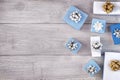 Copy space on a light wooden background. Christmas composition of white and blue gift boxes with beautiful bows. Royalty Free Stock Photo