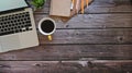 Copy space office desk with laptop, coffee, notepad and pencil with wood table top view.