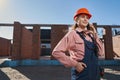 Determined lady in builder gear having a phone conversation