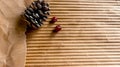 Pine cones and cranberries on the background of corrugated cardboard. Greeting card template with copy space Royalty Free Stock Photo