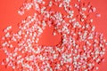 Copy space on red background with lots of small red hearts and a big gingerbread red heart on the right with white sugar buttons Royalty Free Stock Photo
