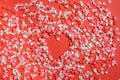Copy space on red background with lots of small red hearts and a big gingerbread red heart on the right with white sugar buttons Royalty Free Stock Photo