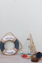 Copy space of set of lifebuoy, boat, compass, starfish on a light gray background. Vacation on the sea Royalty Free Stock Photo
