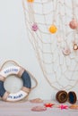 Copy space of set of lifebuoy, compass, starfish on a light gray background. Vacation on the sea Royalty Free Stock Photo
