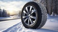 copy space, stockphoto, Brand new winter car tires showcased against a snowy road backdrop. Wintertire in a winte landscape