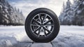 copy space, stockphoto, Brand new winter car tires showcased against a snowy road backdrop. Wintertire in a winte landscape