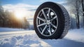 copy space, stockphoto, Brand new winter car tires showcased against a snowy road backdrop. Wintertire in a winte landscape