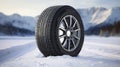 copy space, stockphoto, Brand new winter car tires showcased against a snowy road backdrop. Wintertire in a winte landscape