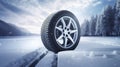 copy space, stockphoto, Brand new winter car tires showcased against a snowy road backdrop. Wintertire in a winte landscape