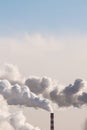 Copy space on vertical banner with heavy smoke from industrial chimneys causing air pollution on the blue sky background Royalty Free Stock Photo